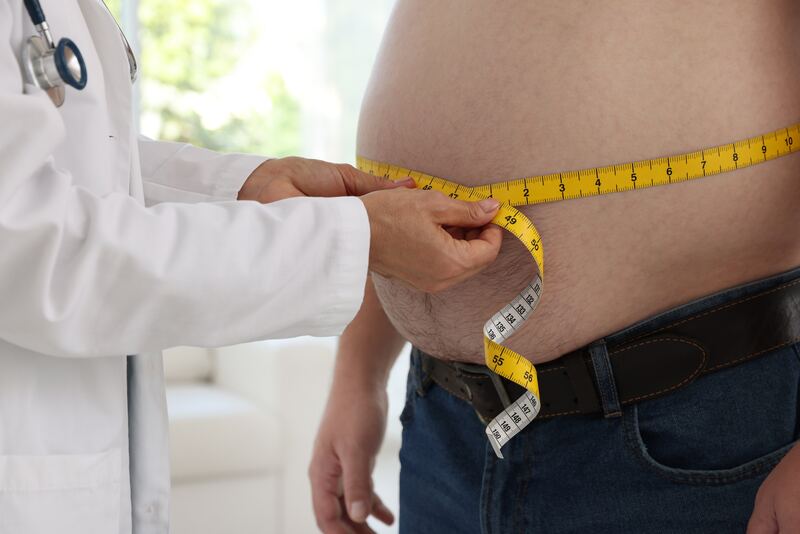 Obesity doctor measuring patient waist for bariatric surgery eligibility in Vizag